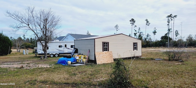 view of outbuilding featuring a lawn