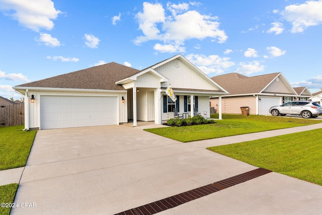 view of front of house with a garage, covered porch, and a front lawn