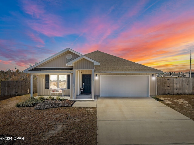 single story home with a garage and covered porch