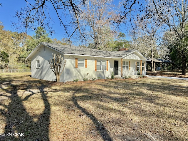 ranch-style home featuring a front yard