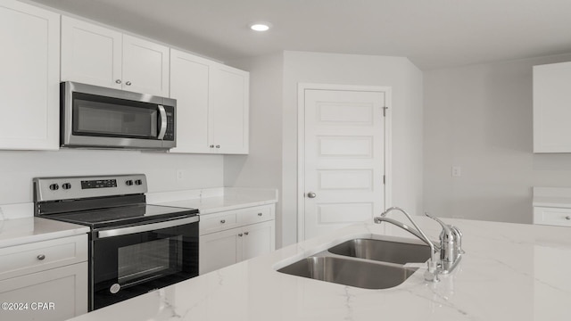 kitchen with white cabinetry, sink, and appliances with stainless steel finishes