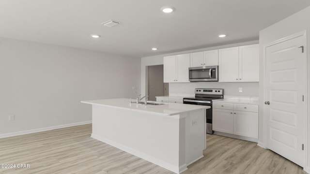 kitchen with white cabinetry, a center island with sink, stainless steel appliances, and sink