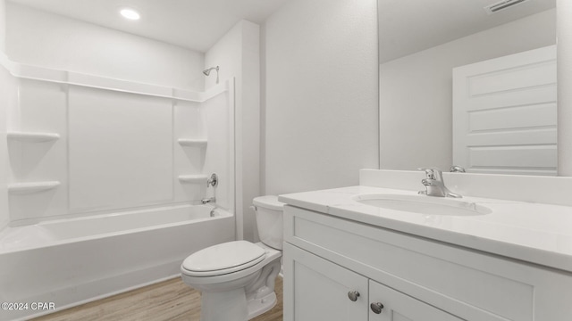 full bathroom with vanity, hardwood / wood-style flooring, toilet, and tub / shower combination