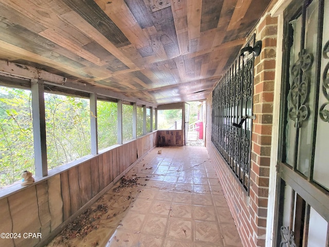 unfurnished sunroom featuring wooden ceiling