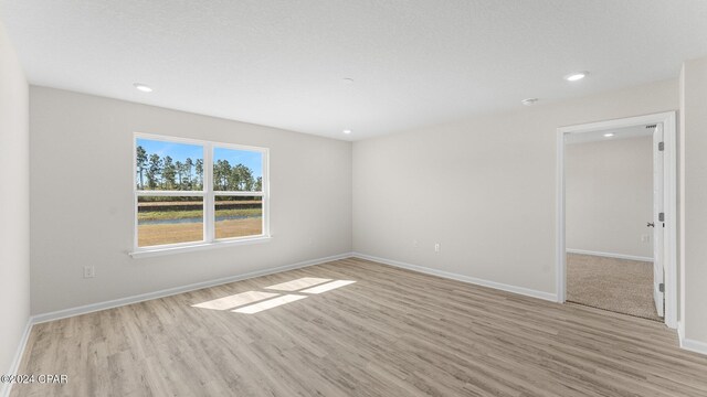 unfurnished room with light hardwood / wood-style flooring