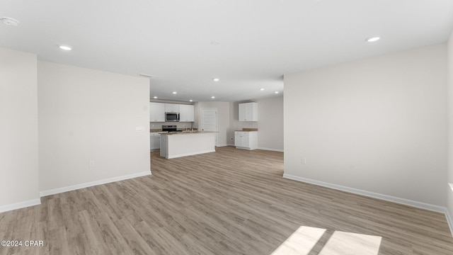 unfurnished living room with light wood-type flooring