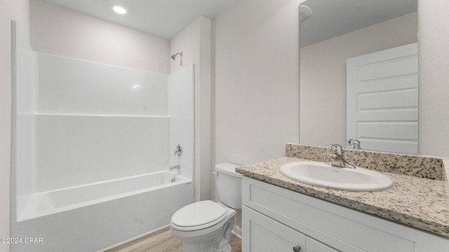 full bathroom featuring vanity, wood-type flooring,  shower combination, and toilet