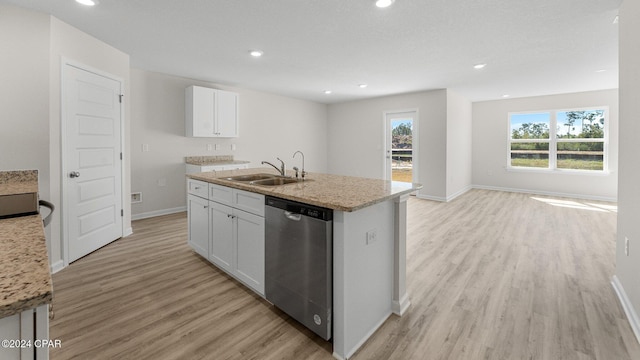 kitchen with white cabinetry, dishwasher, a kitchen island with sink, and light wood-type flooring