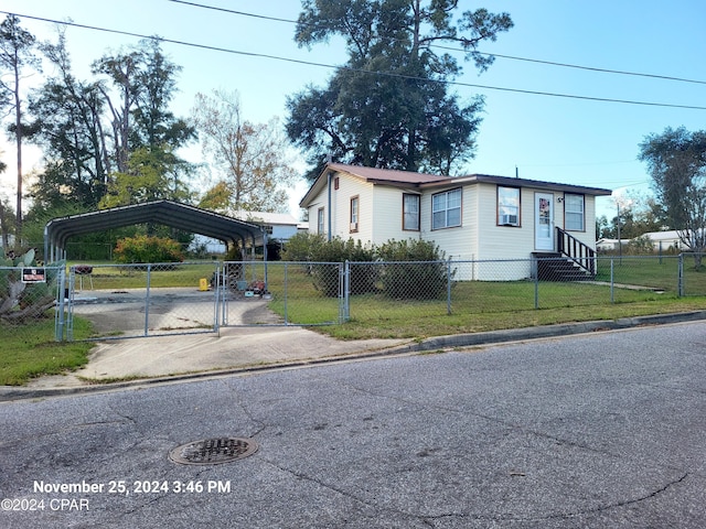 view of front of home with a carport and a front lawn