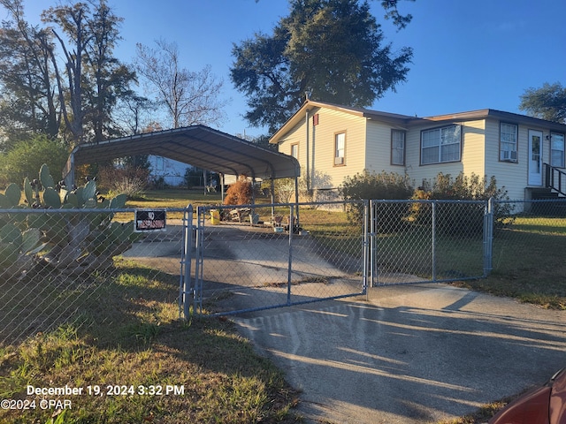 view of front of property with a front yard and a carport