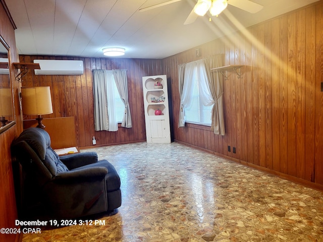 unfurnished room featuring wooden walls, ceiling fan, and a wall unit AC