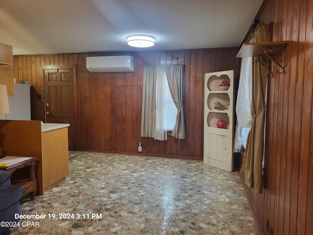 interior space with a wall mounted air conditioner and wooden walls