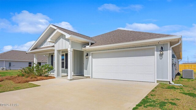 ranch-style home featuring a garage and a front lawn