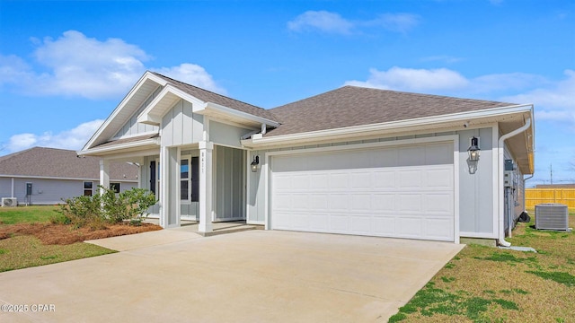 view of front of home featuring a garage and central AC unit