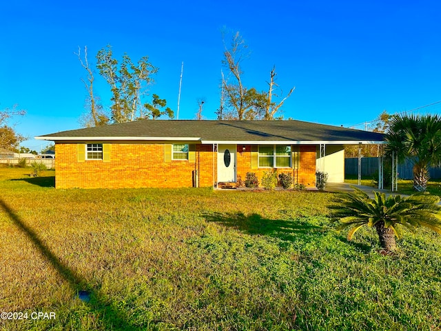 ranch-style home with a carport and a front yard