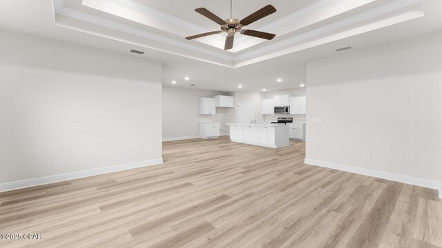 kitchen featuring white cabinetry, sink, and light hardwood / wood-style flooring