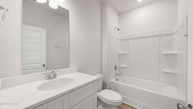 full bathroom with vanity, hardwood / wood-style flooring, shower / washtub combination, and toilet