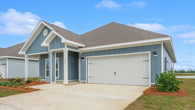 ranch-style house featuring driveway, a garage, board and batten siding, and roof with shingles