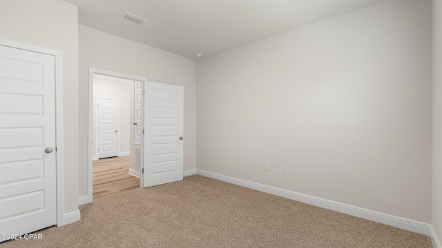 unfurnished bedroom with light carpet