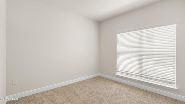 empty room with light colored carpet