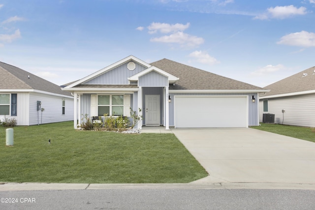 ranch-style home with central AC unit, a garage, and a front lawn