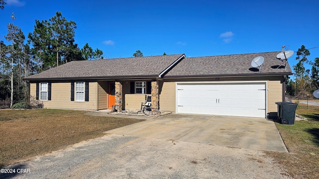 single story home featuring a front lawn and a garage