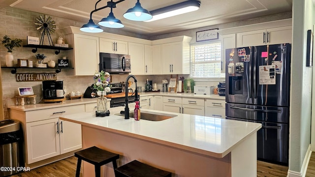 kitchen with white cabinets, sink, decorative light fixtures, dark hardwood / wood-style flooring, and stainless steel appliances