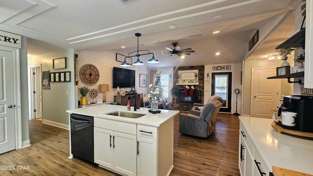 kitchen with sink, decorative light fixtures, dishwasher, white cabinetry, and lofted ceiling