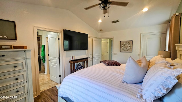 bedroom with light hardwood / wood-style floors, ceiling fan, and lofted ceiling