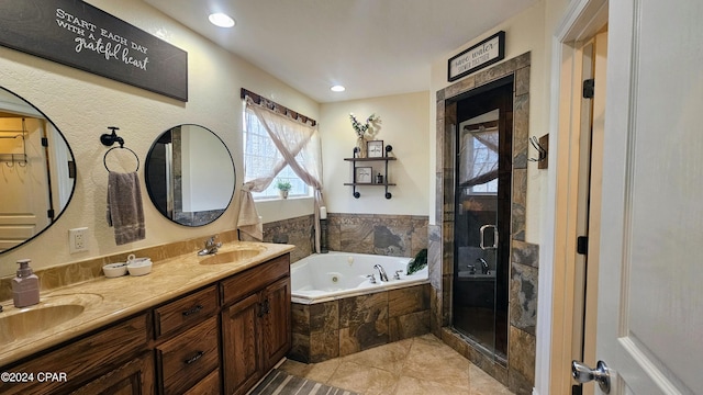 bathroom with tile patterned floors, vanity, and separate shower and tub