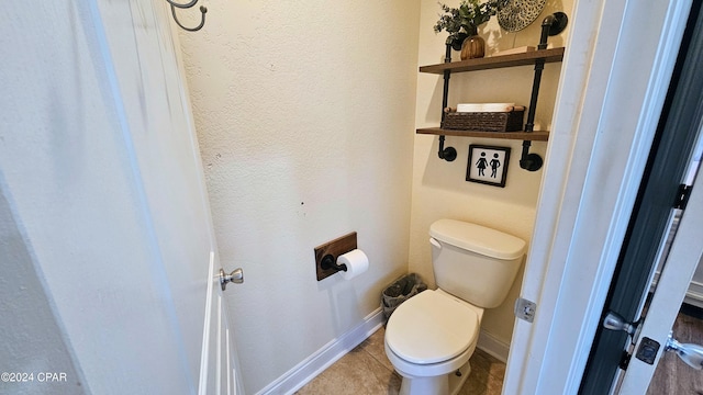 bathroom featuring tile patterned floors and toilet