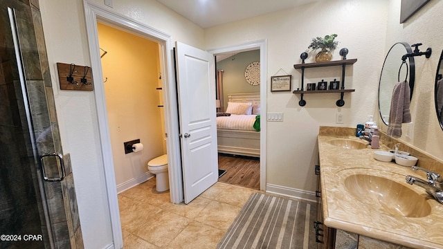 bathroom with tile patterned flooring, vanity, toilet, and an enclosed shower