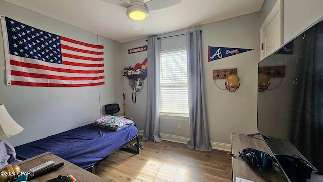 bedroom featuring wood-type flooring and ceiling fan