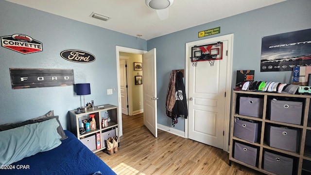 bedroom with wood-type flooring and ceiling fan