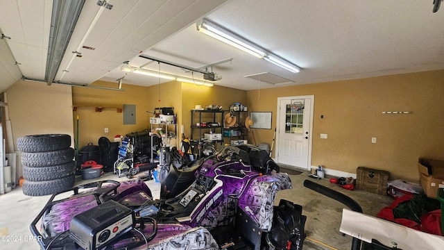 garage featuring electric panel and a garage door opener