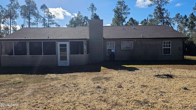 rear view of house with a yard