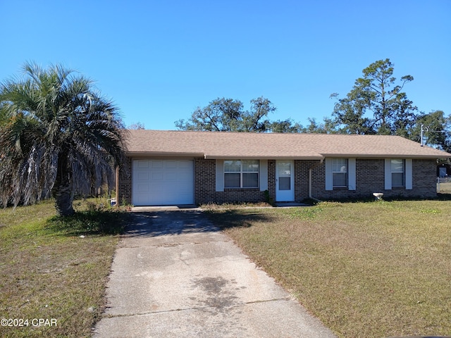 single story home with a garage and a front lawn