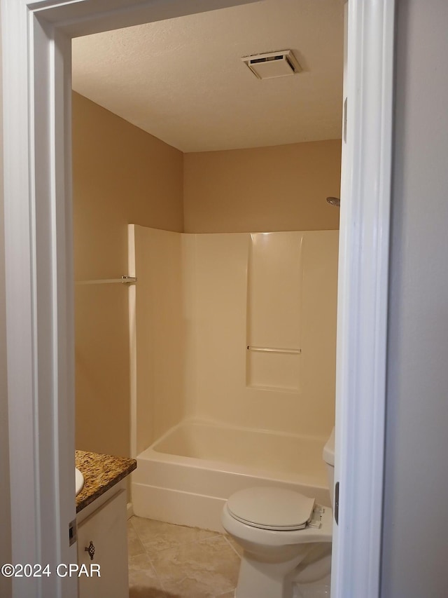 full bathroom with tile patterned floors, shower / bathing tub combination, vanity, and toilet