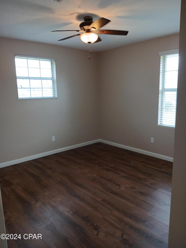 empty room featuring dark hardwood / wood-style floors and ceiling fan