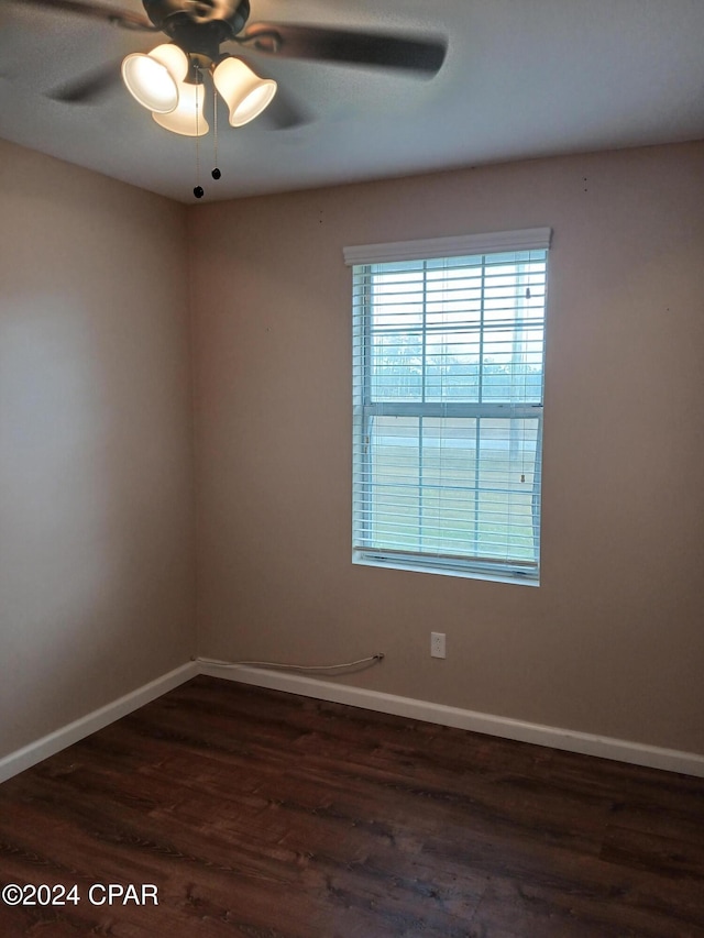 spare room featuring ceiling fan and dark hardwood / wood-style flooring