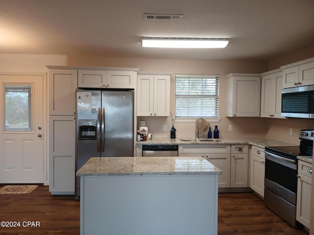 kitchen with white cabinets, light stone countertops, sink, and appliances with stainless steel finishes