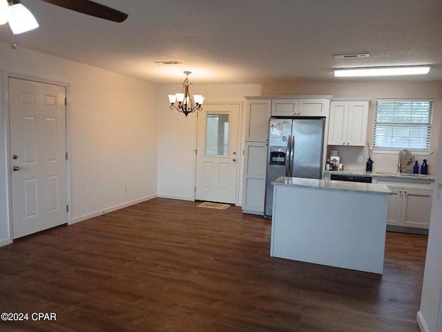 kitchen featuring white cabinetry, sink, dark hardwood / wood-style flooring, stainless steel fridge, and decorative light fixtures