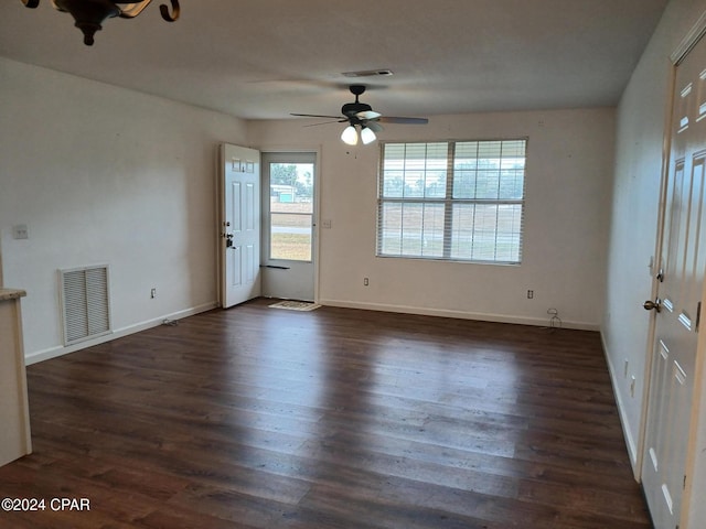 unfurnished room featuring ceiling fan and dark wood-type flooring