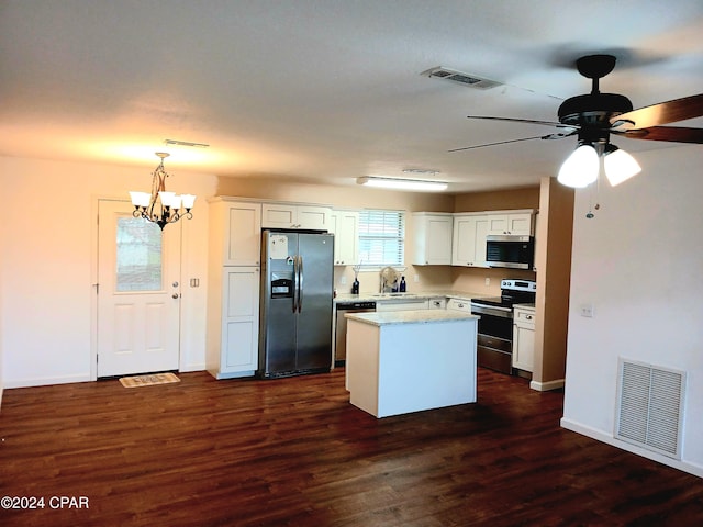 kitchen with white cabinetry, hanging light fixtures, a kitchen island, ceiling fan with notable chandelier, and appliances with stainless steel finishes