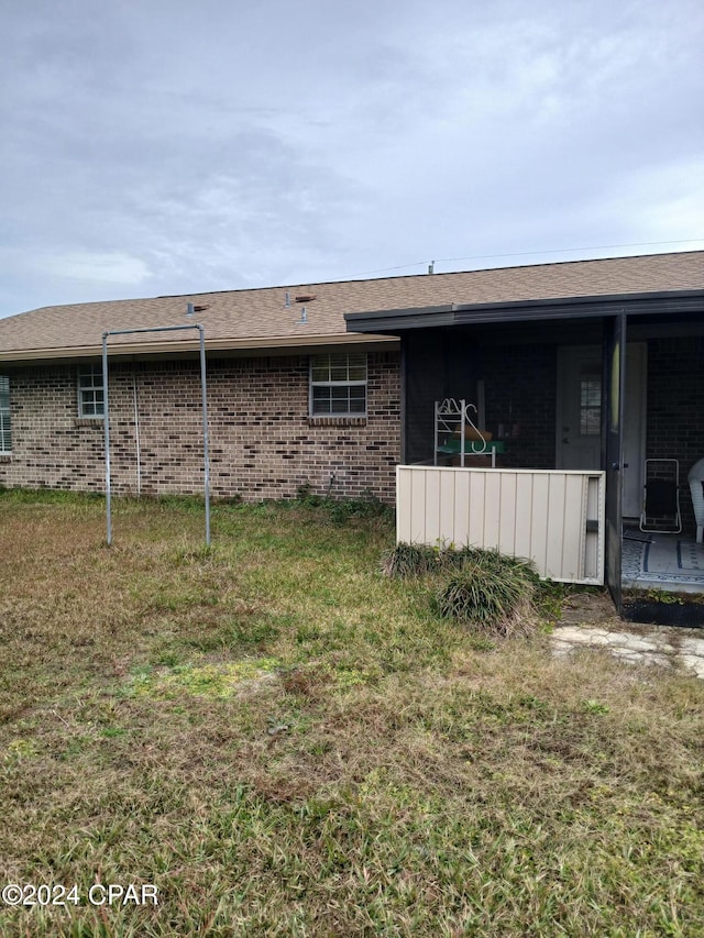 rear view of property with a yard