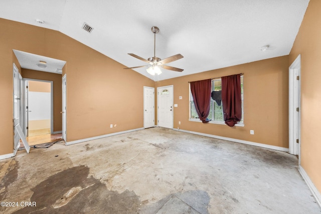 unfurnished room featuring ceiling fan, vaulted ceiling, and concrete floors