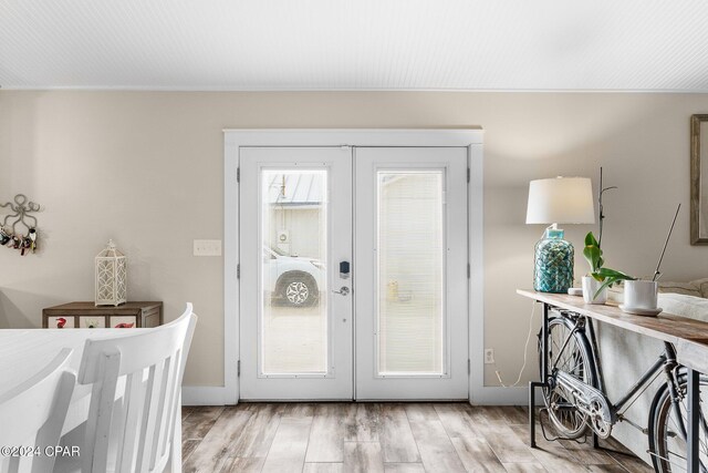 doorway featuring french doors and light wood-type flooring