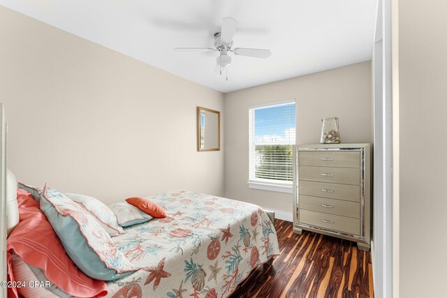 bedroom with ceiling fan and dark hardwood / wood-style floors