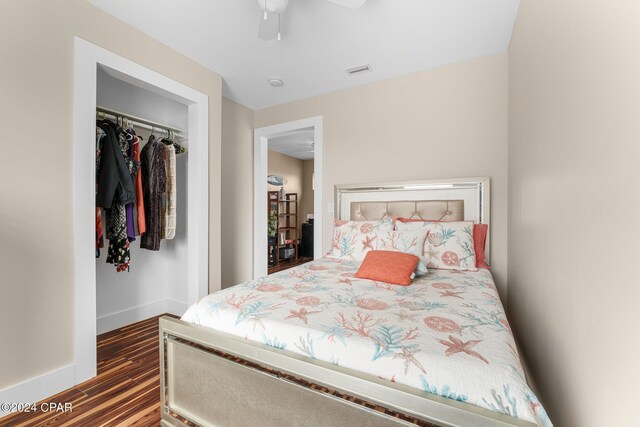 bedroom with ceiling fan, dark hardwood / wood-style floors, and a closet