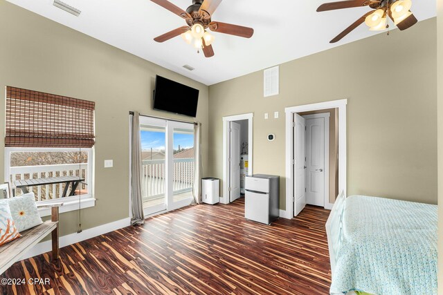 bedroom featuring dark hardwood / wood-style flooring, white refrigerator, access to outside, and ceiling fan